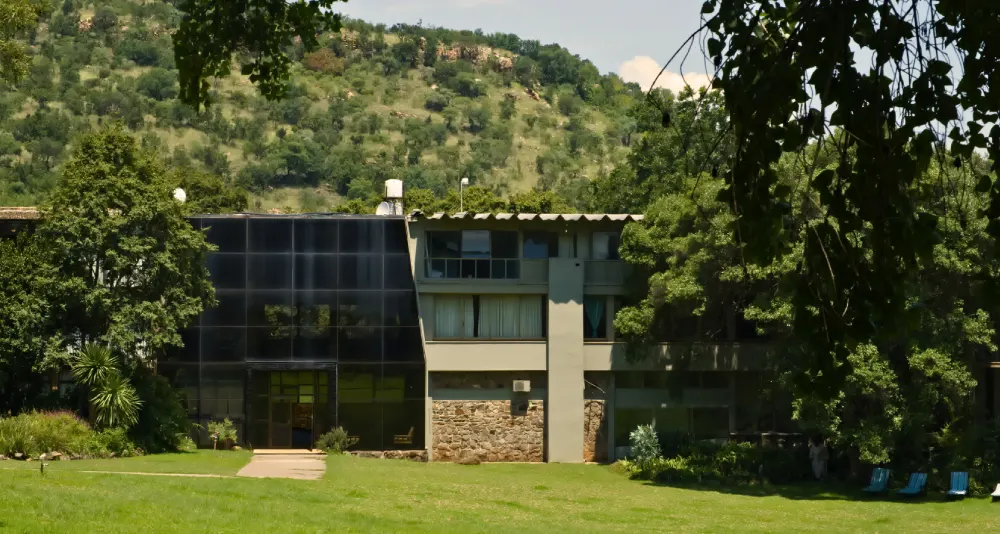 Hoogland Health Hydro main building surrounded by trees in the Hennopsriver Valley